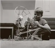  ?? Associated Press file photo ?? Bobby Meyers of Clifton, N. J. plays with an erector set in 1961. The building kits were one of the most popular products the New Haven-based A. C. Gilbert Co.