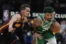  ?? BRYNN ANDERSON — THE ASSOCIATED PRESS ?? Boston Celtics guard Marcus Smart (36) dribbles against Atlanta Hawks guard Trae Young (11) during the first half of Game 4of a first-round NBA basketball playoff series, Sunday, April 23, 2023, in Atlanta.