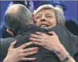  ?? AFP/Getty Images ?? British Prime Minister Theresa May is hugged by her husband, Philip, on Thursday at the Conservati­ve Party’s annual conference in Manchester, England.