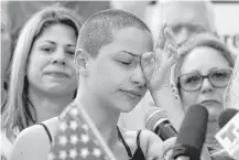  ?? Rhona Wise / AFP/Getty Images ?? “We are up here standing together because if all our government and president can do is send thoughts and prayers, then it’s time for victims to be the change that we need to see,” Marjory Stoneman Douglas High School senior Emma Gonzalez said in her...