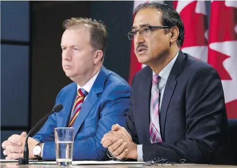  ?? ADRIAN WYLD/ THE CANADIAN PRESS ?? Natural Resources Minister Amarjeet Sohi, right, announces details about the government’s plan for the Trans Mountain expansion in Ottawa on Wednesday. Sohi declined to give a timeline on a new round of consultati­ons about the project with Indigenous groups.