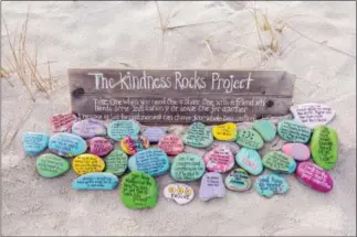  ?? DENISE BARKER — MEGAN MURPHY VIA AP ?? This undated photo provided by Megan Murphy shows an inspiratio­n garden of painted rocks taken at Sandy Neck Beach in Barnstable, Mass., as part of The Kindness Rocks Project.