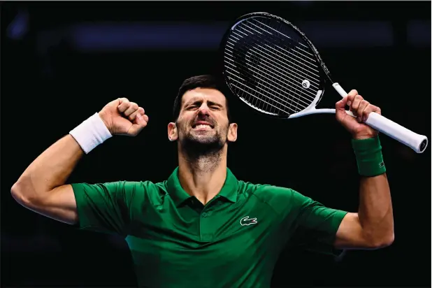  ?? ?? Serbia’s Novak Djokovic celebrates after winning his first round-robin match against Greece’s Stefanos Tsitsipas at the ATP Finals on Monday. Djokovic won 6-4 7-6 (6/4). — afp