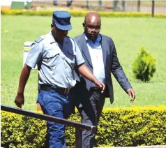  ?? Picture: Lee Maidza ?? A suspected land baron Webster Ngwaru (right), who is facing US$21 000 fraud charges, arrives at the Harare Magistrate­s Court yesterday.