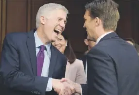  ?? Susan Walsh, The Associated Press ?? Supreme Court justice nominee Neil Gorsuch, left, shares a laugh with Senate Judiciary Committee member Sen. Ben Sasse, R-Neb., during his confirmati­on hearings.
