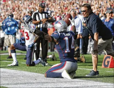  ?? MICHAEL DWYER / ASSOCIATED PRESS ?? New England’s Brandin Cooks is cheered by the Foxborough, Mass., crowd after his winning catch in the last seconds. Cooks was among players booed when they protested during the national anthem.