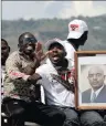  ??  ?? Supporters of Burundi President Pierre Nkurunziza carry his picture. PICTURE: REUTERS