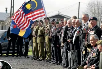  ??  ?? Soldiers of the Invercargi­ll Garrison 2/4 RNZIR formed a guard of honour during the service for Allister George Buchanan on Saturday. Inset, Buchanan’s sister, Kathy Wright, 79, lays a bouquet of flowers. ROBYN EDIE/STUFF