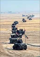  ?? KHALID MOHAMMED/AP ?? An Iraqi military convoy advances Monday toward the town of Tob Zawa, less than 6 miles from Mosul.