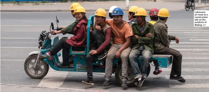  ??  ?? Labourers en route to a constructi­on site on the outskirts of Beijing