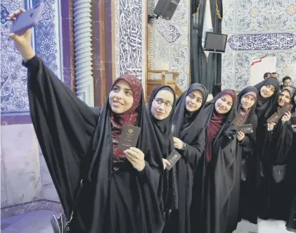  ?? PICTURE: EBRAHIM NOROOZI/AP ?? 0 Voters pose for a selfie during the parliament­ary elections at a polling station in Tehran