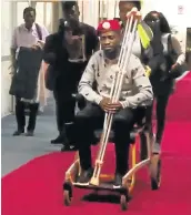  ?? Picture: REUTERS/NICHOLAS OPIYO ?? TORTURED: Bobi Wine is seen in a wheelchair before his departure from Entebbe Airport, in Uganda in this still image taken from a social media video