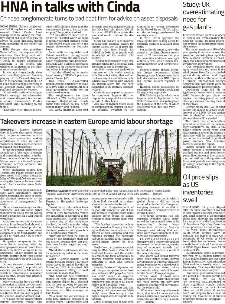  ??  ?? Chronic situation: Workers riding on a tractor during the hops harvest season in the village of Rocov, Czech Republic. Labour shortage limited production at 44% of Czech business in the third quarter. — Reuters