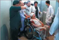  ?? HAMED SARFARAZI / ASSOCIATED PRESS ?? Relatives assist a wounded man in a hospital after a suicide attack on a mosque in Heart, Afghanista­n, on Tuesday.