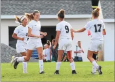  ?? AUSTIN HERTZOG - DIGITAL FIRST MEDIA ?? Above, Boyertown’s Lauren Haley (2) is congratula­ted by Kaleigh Gallagher (9) and other teammates after scoring her second goal Friday. against Methacton.