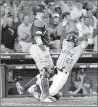  ?? AP/DAVID J. PHILLIP ?? Houston Astros’ second baseman Jose Altuve (27) scores one of four sixth-inning runs to help lift them to an 8-2 victory over the Boston Red Sox in the American League division series. The Astros lead the series 2-0.