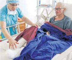  ?? EPA ?? Rescued Taiwanese trekker Liang Sheng Yueh is checked by Dr Chakra Raj Pandey a day after he was successful­ly rescued via helicopter, in Kathmandu, Nepal yesterday.