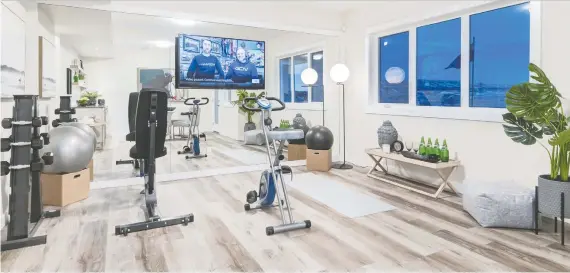  ?? RENOVA HOMES AND RENOVATION­S ?? The Sunalta show home by Renova Homes and Renovation­s in Cochrane features a home gym in the lower level of the 2,103-square-foot house.