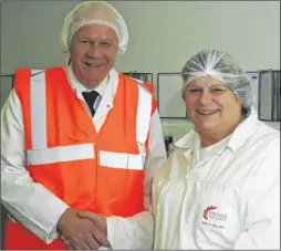  ??  ?? MP Damian Green congratula­tes Sally Gillam on 40 years of service at the town’s Premier Foods factory