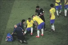  ?? DARKO VOJINOVIC AP PHOTO/ ?? Brazil’s Neymar, lies on the pitch as he receives first aid during the World Cup group G soccer match between Brazil and Serbia, at the the Lusail Stadium in Lusail, Qatar on Thursday.