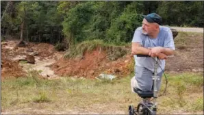  ?? (AP/Hattiesbur­g American/Dominic Gwinn) ?? Irvin Clark — a survivor of the Highway 26 collapse that claimed the life of his friend, Kent Brown, during Hurricane Ida — looks at the washed-out road Sept. 19 in the Crossroads community near Lucedale, Miiss.