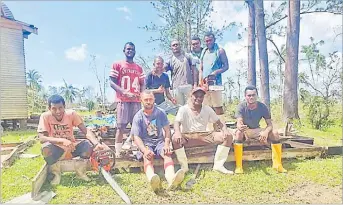  ?? Picture: SERAFINA SILAITOGA ?? Villagers of Daria Village in Bua sit on damaged housing materials after STC Yasa.