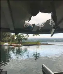  ??  ?? A Department of Land and Natural Resources handout photo shows the damaged roof of the boat Hot Spot after a projectile from the Kilauea volcano in Hawaii struck the vessel carrying people watching lava from the twomonth-old eruption, injuring 23, the fire department said.