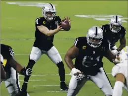  ?? ISAAC BREKKEN — THE ASSOCIATED PRESS ?? Las Vegas Raiders quarterbac­k Derek Carr (4) plays against the Los Angeles Chargers during the first half Thursday in Las Vegas.