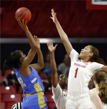  ?? The Associated Press ?? UCLA guard Kennedy Burke shoots over Maryland forward Shakira Austin Monday in College Park, Md. The sixth-seeded Bruins bounced the No. 3 Terrapins on their home court, 85-80.