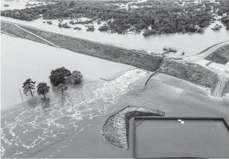  ?? Brett Coomer / Staff file photo ?? Water is released from the Barker Reservoir in the aftermath of Hurricane Harvey on Aug. 29, 2017. Harris County will study whether undergroun­d tunnels could be built to move stormwater to the Ship Channel.