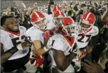  ?? DOUG BENC — THE ASSOCIATED PRESS FILE ?? In this Monday file photo ,Georgia tailback Sony Michel (1) celebrates with teammates after scoring the game-winning touchdown in the second overtime period to give Georgia a 54-48win over Oklahoma in the Rose Bowl NCAA college football game in...