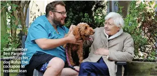  ?? ?? Staff member Ben Pargeter introduces his dog Rufus the cockapoo to resident Jean