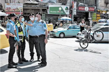  ?? SAMAR HAZBOUN/FOR THE NEW YORK TIMES ?? Palestinia­n security officers, seen July 1 in the West Bank city of Nablus, are often scorned for working with Israel.