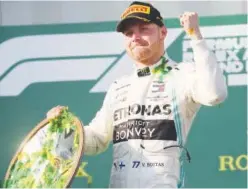  ?? Agence France-presse ?? Mercedes’ Valtteri Bottas celebrates on the podium after winning the Formula One Australian Grand Prix on Sunday.