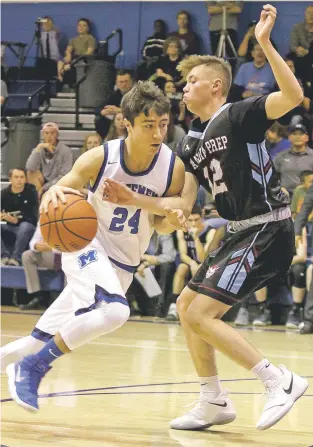  ?? JANE PHILLIPS/FOR THE NEW MEXICAN ?? St. Michael’s Antonio Gabaldon, left, drives on Albuquerqu­e Sandia Prep’s David Gelb on Saturday in the State Basketball Tournament in Perez-Shelley Gymnasium. The Jaguars won, 72-65, in overtime and advance to face top seed Bernalillo on Wednesday in...