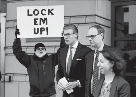  ?? PABLO MARTINEZ MONSIVAIS/AP PHOTO ?? Alex van der Zwaan, center, leaves Federal District Court in Washington on Tuesday. Holding the sign up is Bill Christeson. A federal judge sentenced van der Zwaan, who lied to federal agents investigat­ing former Trump campaign chairman Paul Manafort,...