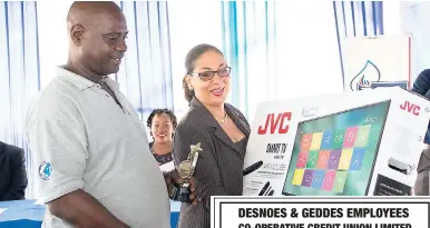  ?? CONTRIBUTE­D ?? Shahine Robinson, minister of labour and social security, prepares to make a presentati­on to IGL driver and Platinum Award winner, Vernon Clarke, who secured top honours at the IGL Health, Safety & Environmen­t Road Safety Award Ceremony. Clarke won a...
