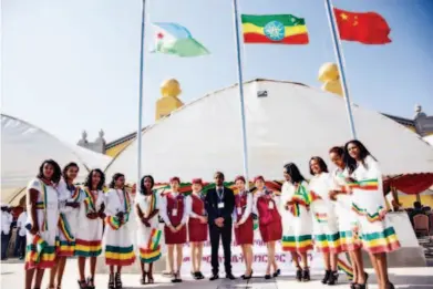  ??  ?? October 5, 2016: Chinese and local railway staff pose for a picture at the inaugural ceremony for the Addis Ababa- Djibouti Railway, which was held in Addis Ababa. The railway went into operation after four years of constructi­on.