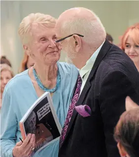  ?? MIKE PEARSON TO R S TA R ?? Stoney Creek Citizen of the Year Georgina Beattie receives a standing ovation and embrace from her husband, Stewart, during the award presentati­on at the Stoney Creek Chamber of Commerce’s annual Community Achievemen­t Awards gala May 18.