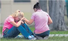  ?? Picture: AP. ?? Women outside the family reunificat­ion site after the shooting at Santa Fe High School.