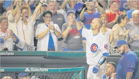  ?? | AP ?? Cubs catcher David Ross, who received mutliple curtain calls Sunday, waves to the crowd after hitting a solo home run in the fifth inning against the Cardinals atWrigley Field.