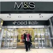  ??  ?? Spark rekindled: A customer leaves a Marks & Spencer store in central London. The food, homeware and clothing chain beat forecasts for Christmas trading.