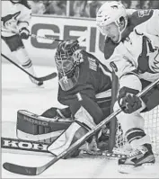  ?? Bret Hartman
Associated Press ?? GOALIE JONAS HILLER of the Ducks protects net against Phoenix winger Shane Doan in third period.