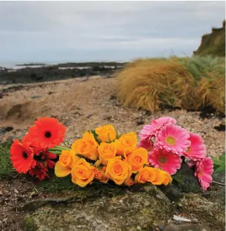  ??  ?? Flowers at the spot where the baby’s remains were found on Bell’s Beach, Balbriggan, Dublin