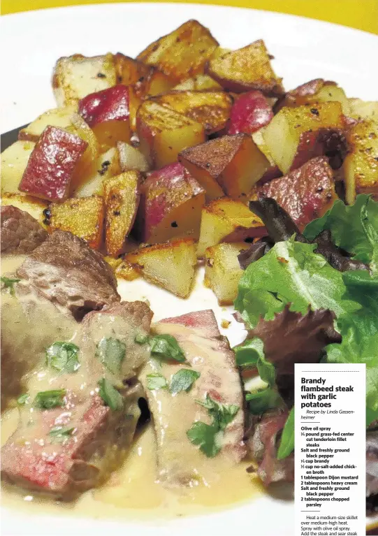  ?? LINDA GASSENHEIM­ER TNS ?? Brandy Flambeed Steak with Garlic Potatoes.