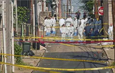  ?? Harry Fisher/The Morning Call via Associated Press ?? Federal and local authoritie­s investigat­e along North Hall Street in Allentown, Pa., on Sunday, after a fiery car explosion rocked the neighborho­od on Saturday night.