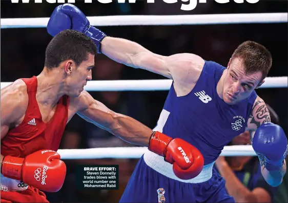  ??  ?? BRAVE EFFORT: HARD TO TAKE: Brendan Irvine’s head drops as Shakhobidi­n Zoirov of Uzbekistan is declared the winner after their flyweight encounter Steven Donnelly trades blows with world number one Mohammed Rabii