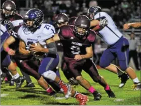  ??  ?? Phoenixvil­le’s Matt Garcia takes a carry as Pottsgrove’s Malik Garner (3) pursues on Friday night.