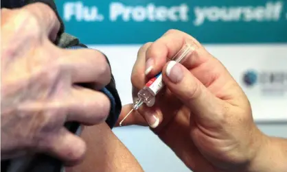  ?? Photograph: David Cheskin/PA ?? A person receives a flu jab. Some drugmakers have pledged to provide their Covid-19 vaccines on a not-for-profit basis during this pandemic.