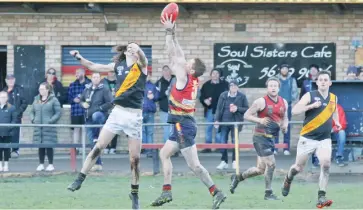  ??  ?? Above: Longwarry’s Aaron Serong judges the flight of the ball best as Lang Lang’s Brock Duggan makes a flying attempt at a spoil.